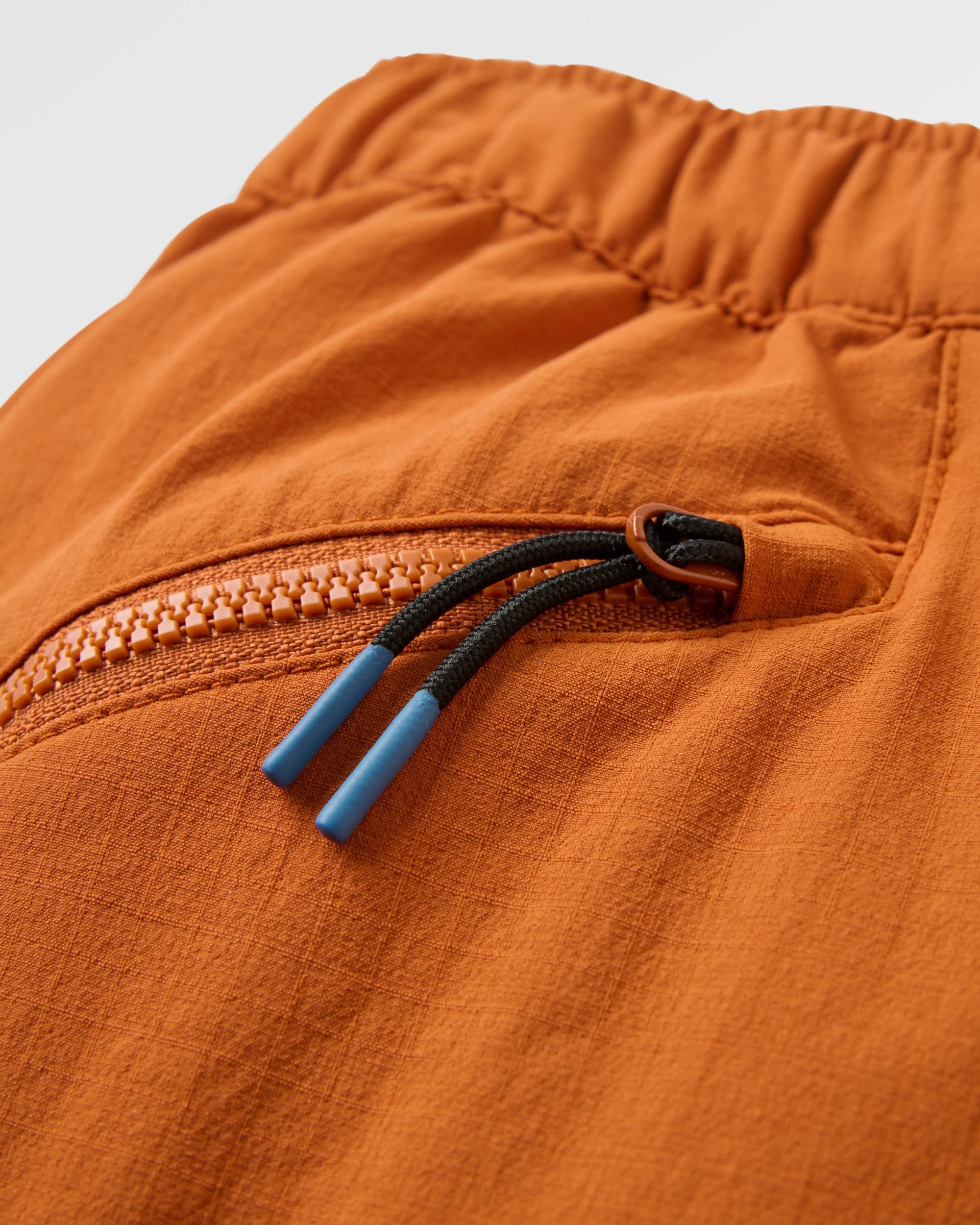 Sandstone Recycled Active Trail Short - Sunset Orange - Flatlay