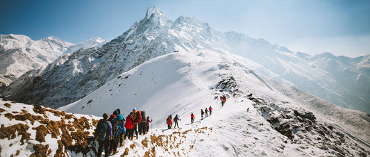 A group hiking through snowy mountains